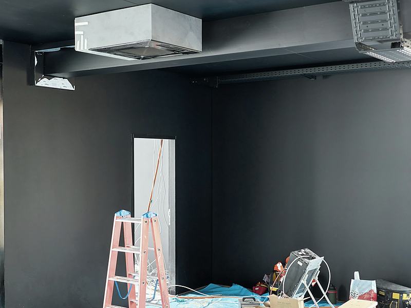 A commercial interior part-way through a fit-out, tools and drop cloths in place