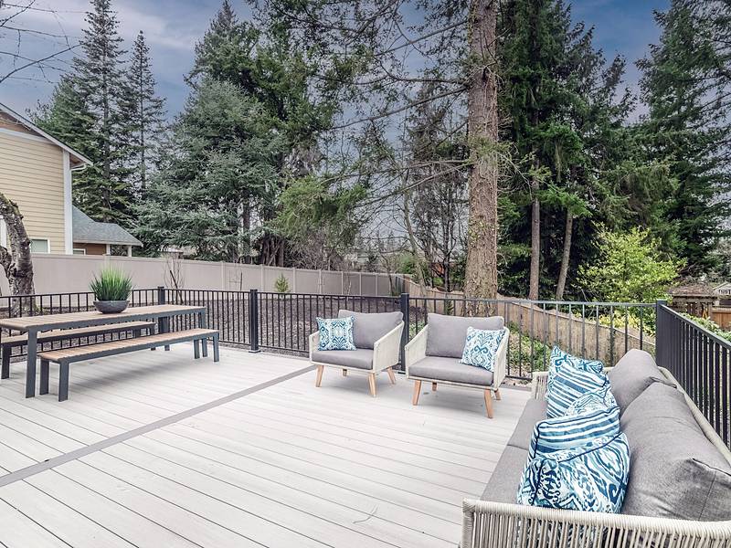 Maintained deck with railings and seating at a residential property