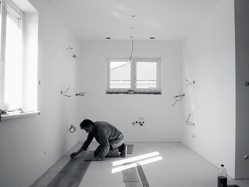 New flooring being laid in an empty room
