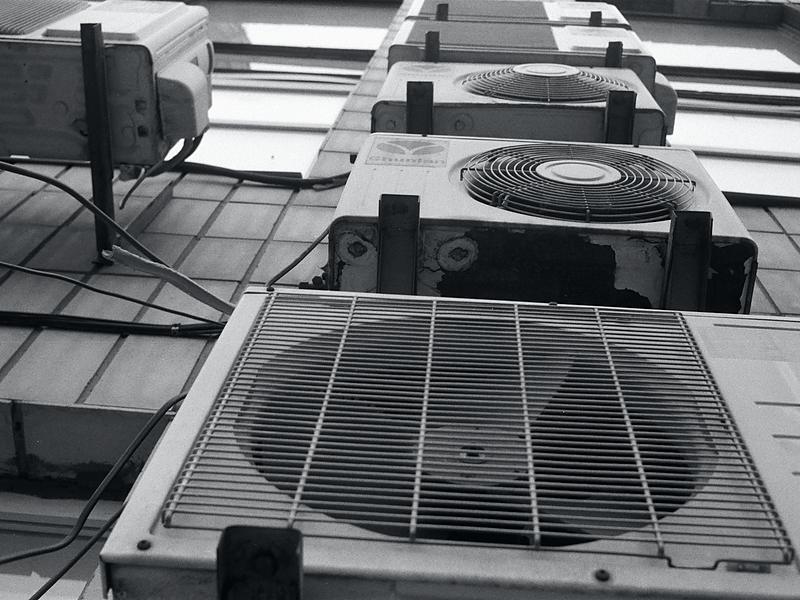 Outdoor condenser units serviced as part of an HVAC maintenance visit