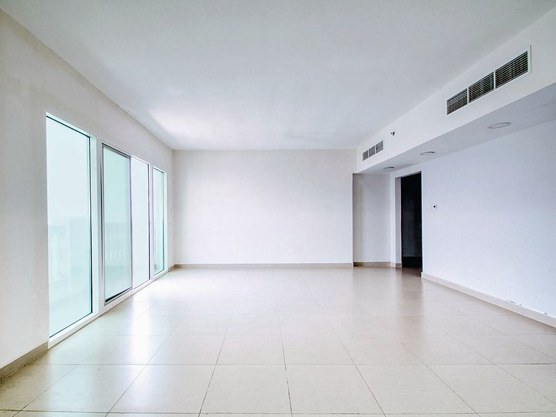The unit finished — floors laid, walls painted, ready to list